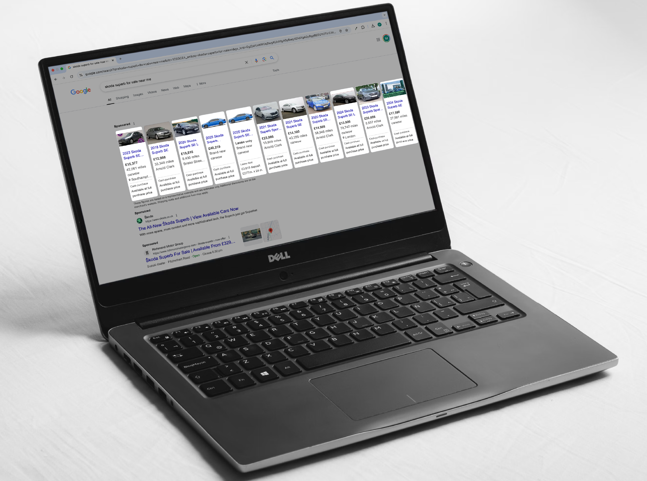 Laptop on a white background with google vehicle ads