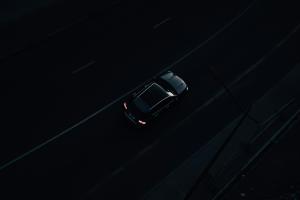 Black car driving in the dark