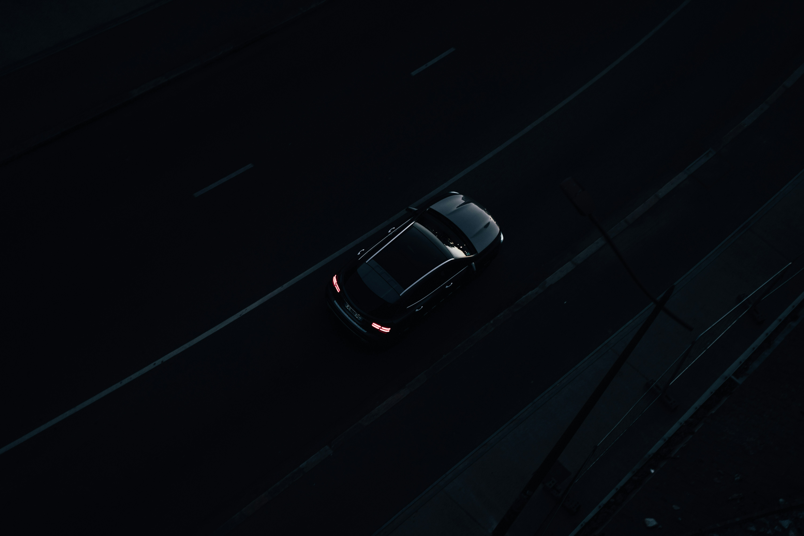 Black car driving in the dark